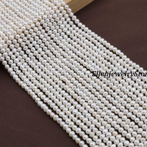 May include: Strands of small, white pearls arranged diagonally across the frame. The pearls are uniform in size and shape, creating a consistent pattern. The background is a solid, dark brown color.