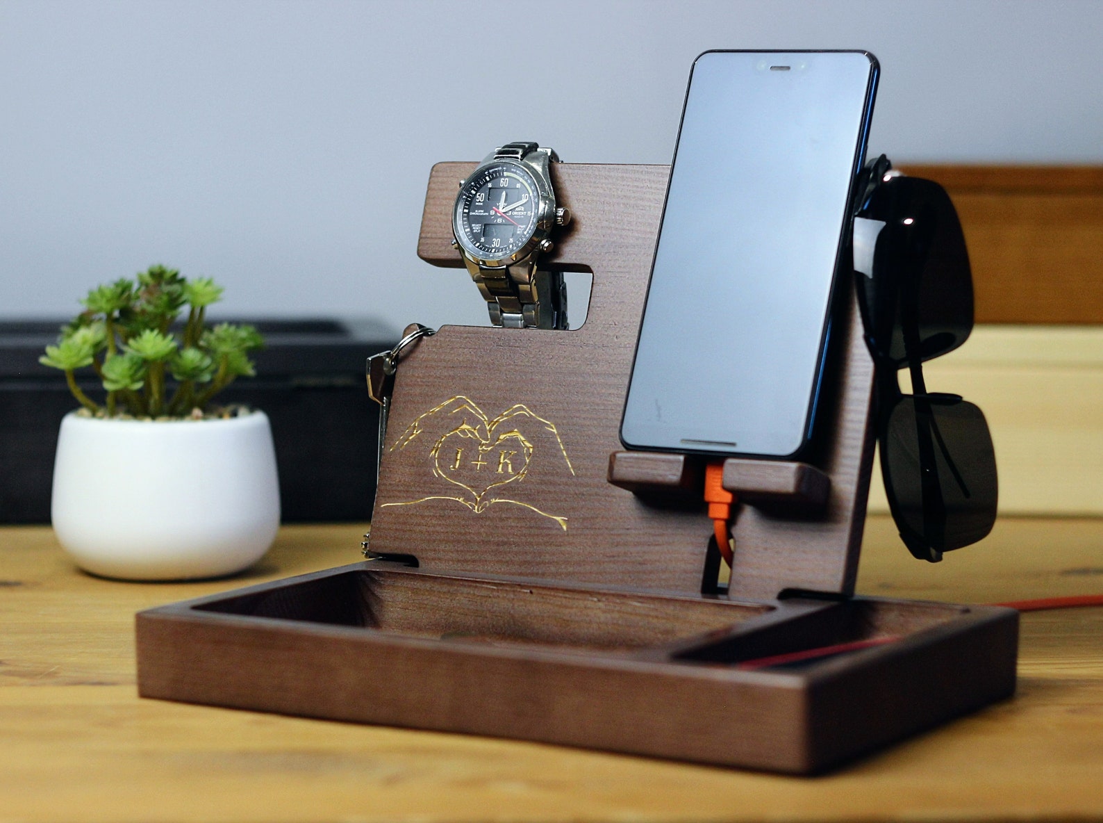 This docking station made of wood will help keep his desk tidy.