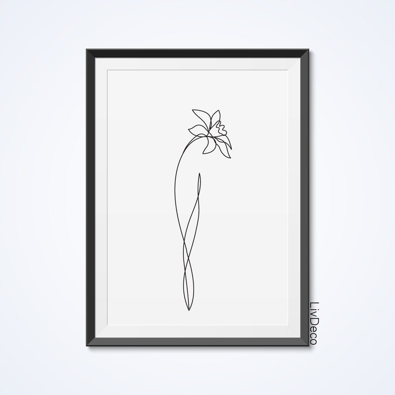May include: A black and white line drawing of a flower in a simple, minimalist style. The flower is depicted with a single stem and a single bloom. The drawing is framed in a black frame.