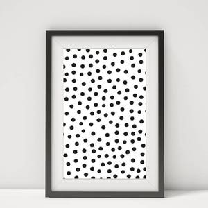 May include: Framed art print featuring a white background with a pattern of evenly spaced black dots. The print is encased in a black frame with a white mat, creating a modern, minimalist aesthetic. The artwork is suitable for various interior design styles.