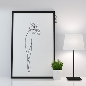 May include: Black and white line art print of a single flower in a black frame. The print is titled "LivDeco".