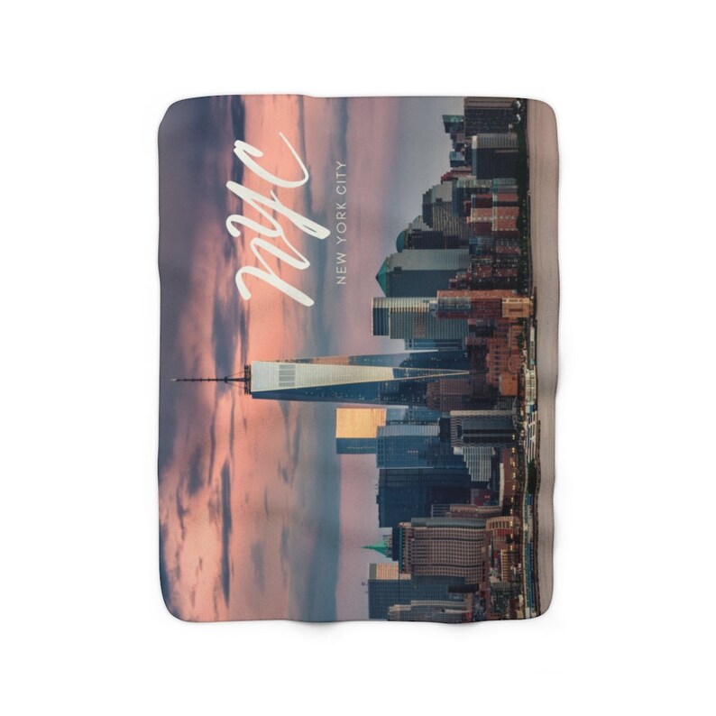 May include: A colorful sunset over the New York City skyline with the text "nyc" and "NEW YORK CITY" written in white.