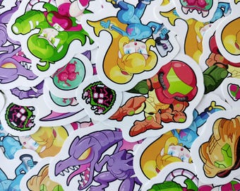 以下が含まれることがあります： ビデオゲームの様々なキャラクターや要素が描かれた、カラフルなダイカットステッカーのコレクション。ステッカーは、鮮やかな色と詳細なデザインで、キャラクターがアクションポーズをとっている様子を示しています。ステッカーは白い背景にあります。