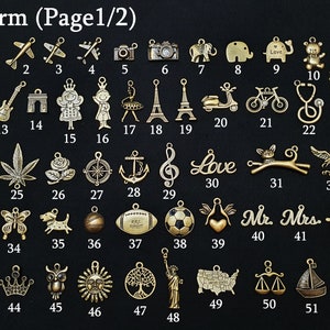 May include: A collection of gold-colored charms, each with a unique design. The charms include airplanes, cameras, animals, musical notes, and various other symbols. The text "Charm (Page 1/2)" is at the top.