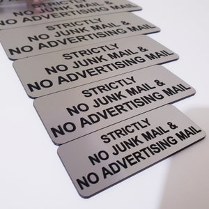 May include: Five silver metal signs with black text that reads "Strictly No Junk Mail & No Advertising Mail".