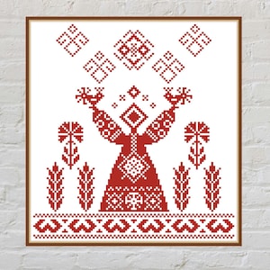 May include: Framed cross-stitch art featuring a red figure with outstretched arms, holding objects, and surrounded by geometric and floral patterns. The design is set against a white background, with a brown frame.