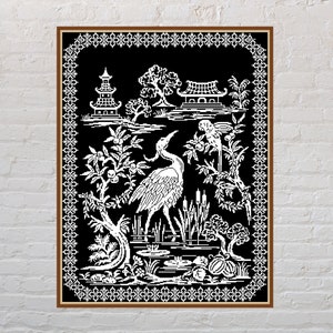 May include: Black and white embroidery design featuring a crane, a parrot, a pagoda, and other Asian-inspired elements. The design is framed in a brown frame with a white border.