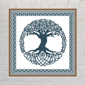 May include: A square cross-stitch pattern featuring a dark blue tree of life design centred within a circular border, all enclosed by a geometric Greek key frame. The entire composition is rendered in dark blue thread against a white background.