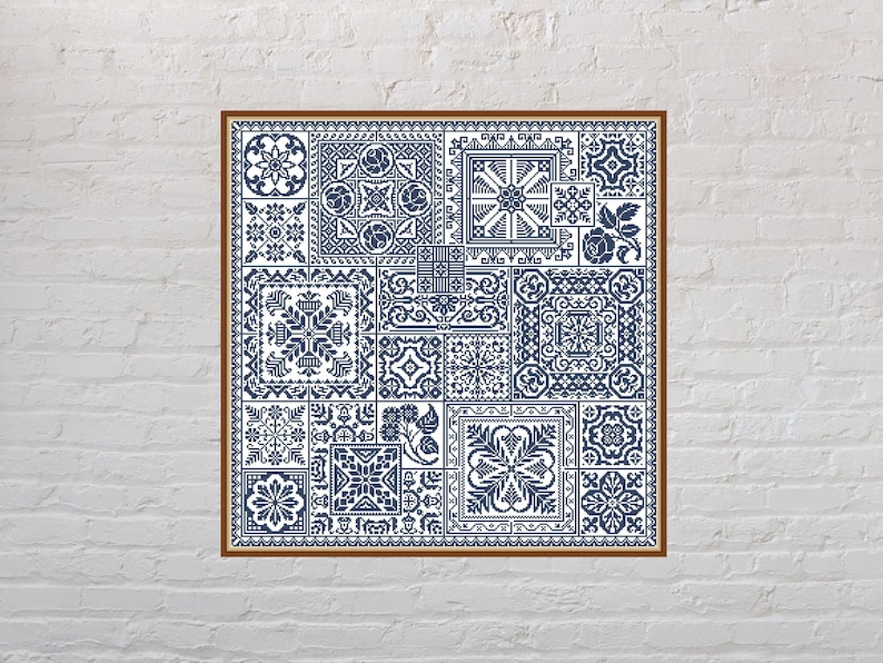 May include: A framed cross-stitch pattern with a blue and white geometric design. The pattern is made up of various squares and rectangles, each with a different design. The frame is brown wood.