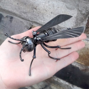 Metal sculpture Wasp, black wasp America. Art wasp figurine. Welded insect Metal black wasp statuette, spark plug.