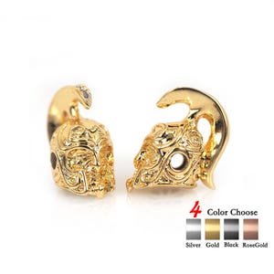May include: Two gold skull-shaped charms with intricate designs. The charms have a hole in the center for attaching to a bracelet or necklace. 4 Color Choose: Silver, Gold, Black, RoseGold.