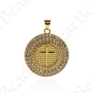 May include: A gold pendant with a cross design surrounded by clear cubic zirconia stones.