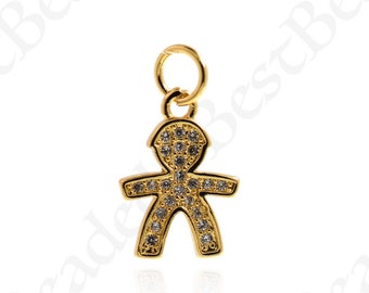 May include: A gold-colored charm in the shape of a stick figure, encrusted with small, clear gemstones. The charm has a loop at the top for attaching to a necklace or bracelet. The design is simple yet elegant, suitable for jewelry.