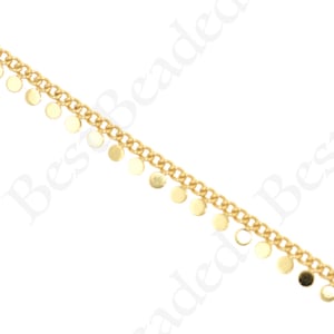 May include: Gold-coloured chain featuring small, round, dangling charms. The chain has a curb link design, and the charms are evenly spaced along one side. Suitable for necklaces, bracelets, or other accessories.