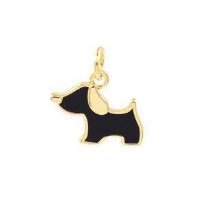 May include: Gold-toned charm featuring a black enamel dog silhouette. The charm has a loop at the top for attaching to a necklace or bracelet.