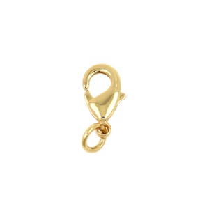 May include: A gold-colored lobster clasp, a jewelry component, is displayed against a white background. The clasp has a curved body with a spring-loaded lever and a small loop for attaching to other jewelry pieces.