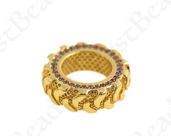 May include: Gold-toned charm with a tire tread design and clear crystal accents.