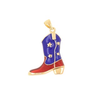 May include: A gold-toned metal pendant shaped like a cowboy boot. The boot features a red foot section and a blue shaft decorated with small gold-colored star cutouts. A small gold loop is attached to the top of the boot for hanging purposes.