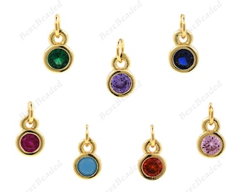 May include: Assortment of gold-tone charms with a single round gemstone in various colors, including green, blue, purple, red, pink, and turquoise.