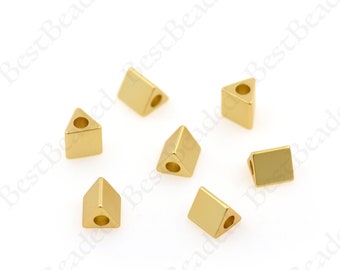 May include: Seven gold-colored triangle-shaped beads with a hole in the center of each bead.