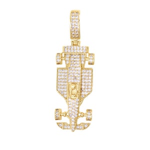 May include: A gold-tone pendant featuring a detailed, diamond-encrusted race car design. The pendant is perfect for adding a touch of luxury and style to any necklace.