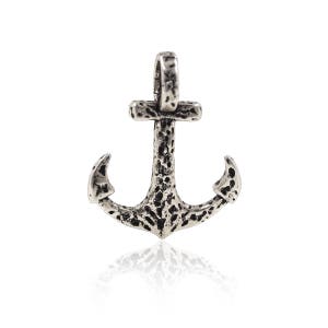 May include: A silver anchor pendant with a textured surface. The anchor has a loop at the top for attaching to a chain.