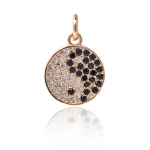 May include: Gold pendant necklace featuring a yin yang symbol with black and white cubic zirconia stones.