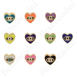 May include: Ten gold heart-shaped charms with an evil eye design. The charms are in various colors including blue, orange, yellow, purple, green, pink, and black.