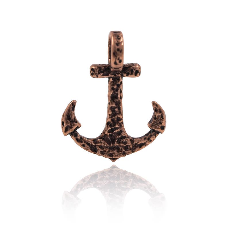 May include: A copper-coloured anchor pendant with a textured surface. The anchor has a loop at the top for attaching to a chain or cord.