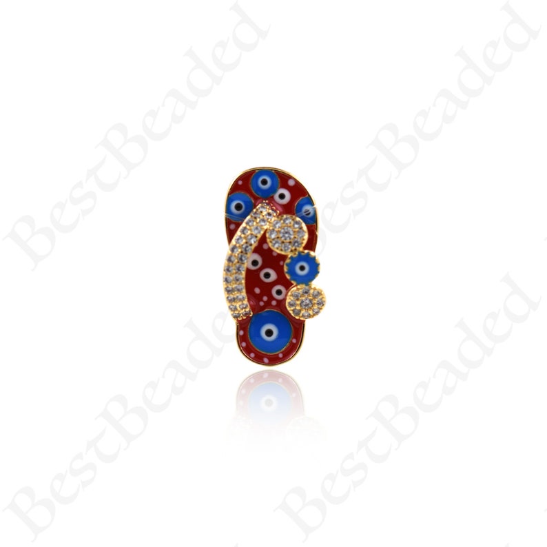 May include: Red and blue enamel flip flop charm with gold accents and white rhinestones. The flip flop has a blue evil eye design.