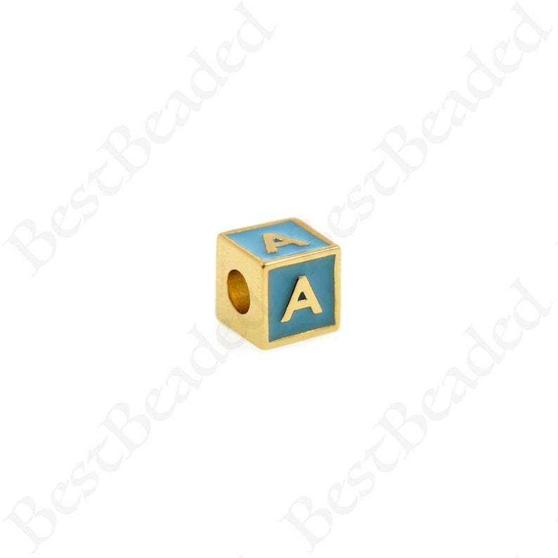 K&ouml;nnte beinhalten: Goldfarbener Alphabet-Perle mit blauer Emaille-Beschichtung. Der Buchstabe "A" ist in Gold auf die Perle gedruckt.