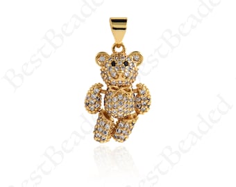May include: Gold-tone pendant charm featuring a teddy bear design with clear and black cubic zirconia stones.