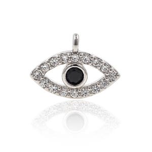 May include: Silver charm featuring a black evil eye design surrounded by clear cubic zirconia stones.