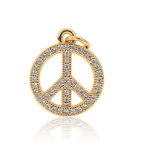 May include: A gold peace sign charm with clear rhinestones. The charm is a popular symbol of peace and love.
