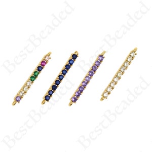 May include: Four gold bar connectors with different colored crystal stones. The connectors have a loop on each end for attaching to jewelry.