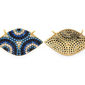 May include: Gold-tone eye charm with blue and white enamel and clear rhinestones. The back of the charm is a gold-tone mesh design.