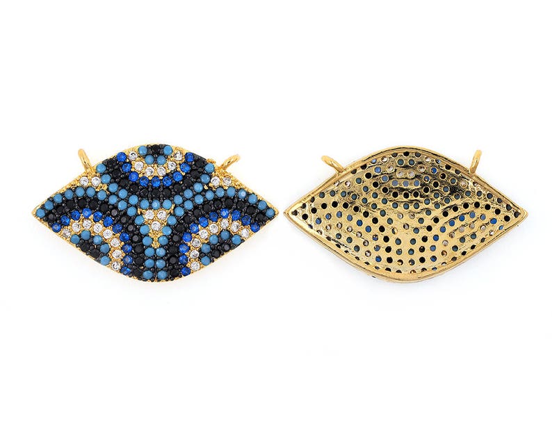 May include: Gold-tone eye charm with blue and white enamel and clear rhinestones. The back of the charm is a gold-tone mesh design.
