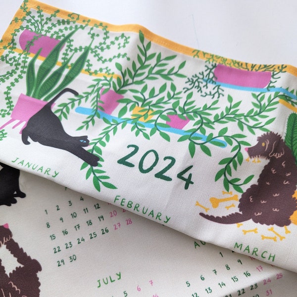 2024 calendar wall hanging with dogs, cats and houseplants. Cotton fabric tea towel or wall decoration. Printed on fabric, washable.