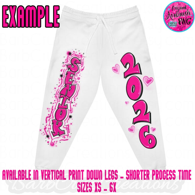 May include: White sweatpants with a drawstring waist, featuring pink airbrushed text that reads "SENIOR" and "2026" with heart accents. The word "EXAMPLE" is at the top. The text "AVAILABLE IN VERTICAL PRINT DOWN LEGS - SHORTER PROCESS TIME SIZES XS - 6X" is at the bottom.