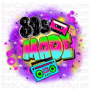 May include: A colorful graphic design with the text "80's Made" in a graffiti style. The design features a cassette tape and a boombox with a purple, pink, blue, green, and yellow color scheme.