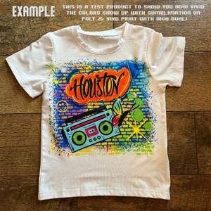 May include: White t-shirt featuring a colourful graphic print of a boombox, a butterfly, and the word "Houston" in graffiti style.