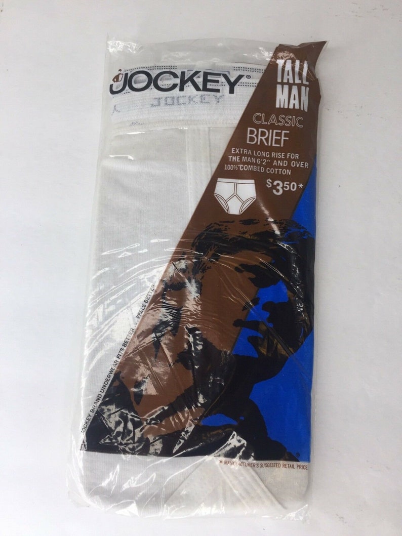 May include: White Jockey brand underwear packaged in plastic. The package features a blue and brown illustration of a man's face. The text on the package reads "Tall Man Classic Brief Extra Long Rise for the Man 6'2" and over 100% Combed Cotton &pound;350*"