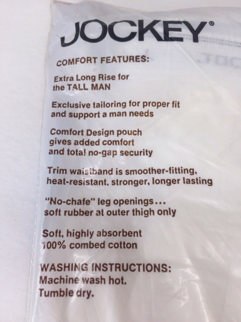 May include: White packaging with brown text describing the features of Jockey underwear. The text includes "Extra Long Rise for the TALL MAN", "Comfort Design pouch", "Trim waistband", "No-chafe" leg openings", "Soft, highly absorbent", "100% combed cotton", "Machine wash hot", and "Tumble dry".
