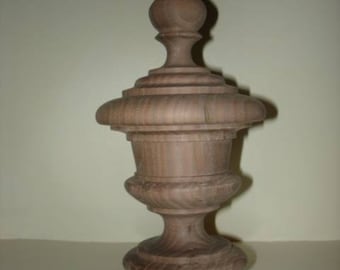 May include: A wooden finial with a rounded top and a fluted base. The finial is a light brown color and has a smooth finish.