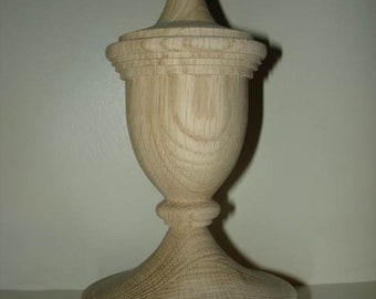May include: A wooden finial with a rounded top and a fluted base. The finial is made of light-colored wood and has a smooth finish.