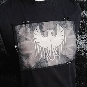 May include: Black sleeveless shirt with a gray and white patch featuring a stylized eagle and a Union Jack flag design.