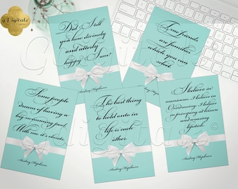 May include: Five rectangular cards with a light blue background, each featuring a white ribbon with a bow at the bottom. The cards display black cursive quotes by Audrey Hepburn, including phrases about friends, closets, and lipstick, with her name printed below.