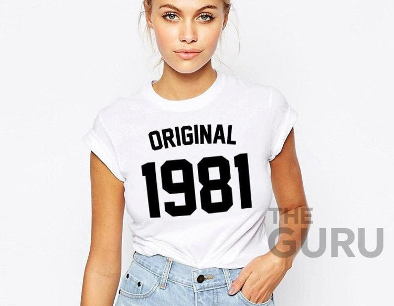 May include: White t-shirt with black text that reads "ORIGINAL 1981".