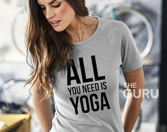 May include: Grey t-shirt with black text that reads "ALL YOU NEED IS YOGA" and "THE GURU" in the bottom right corner.