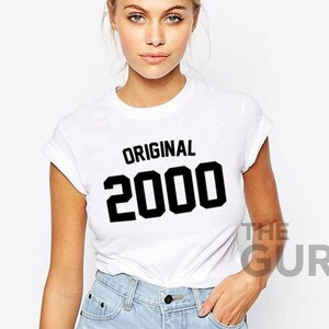 May include: White t-shirt with black text that reads "ORIGINAL 2000".